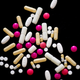 Various pills, tablets, and suppositories on a counter; stock photo.